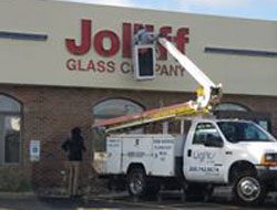 Repairing an exterior building sign at Jolliff Glass